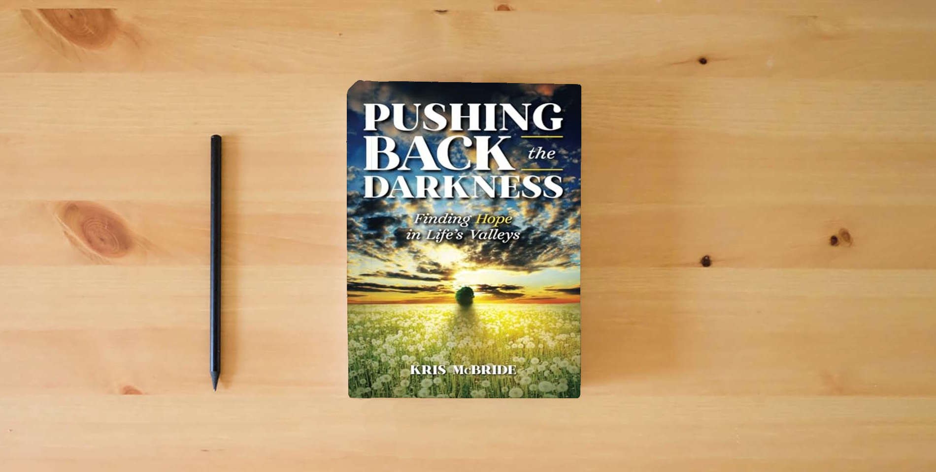 The book Pushing Back the Darkness: Finding Hope in Life's Valleys is on the table