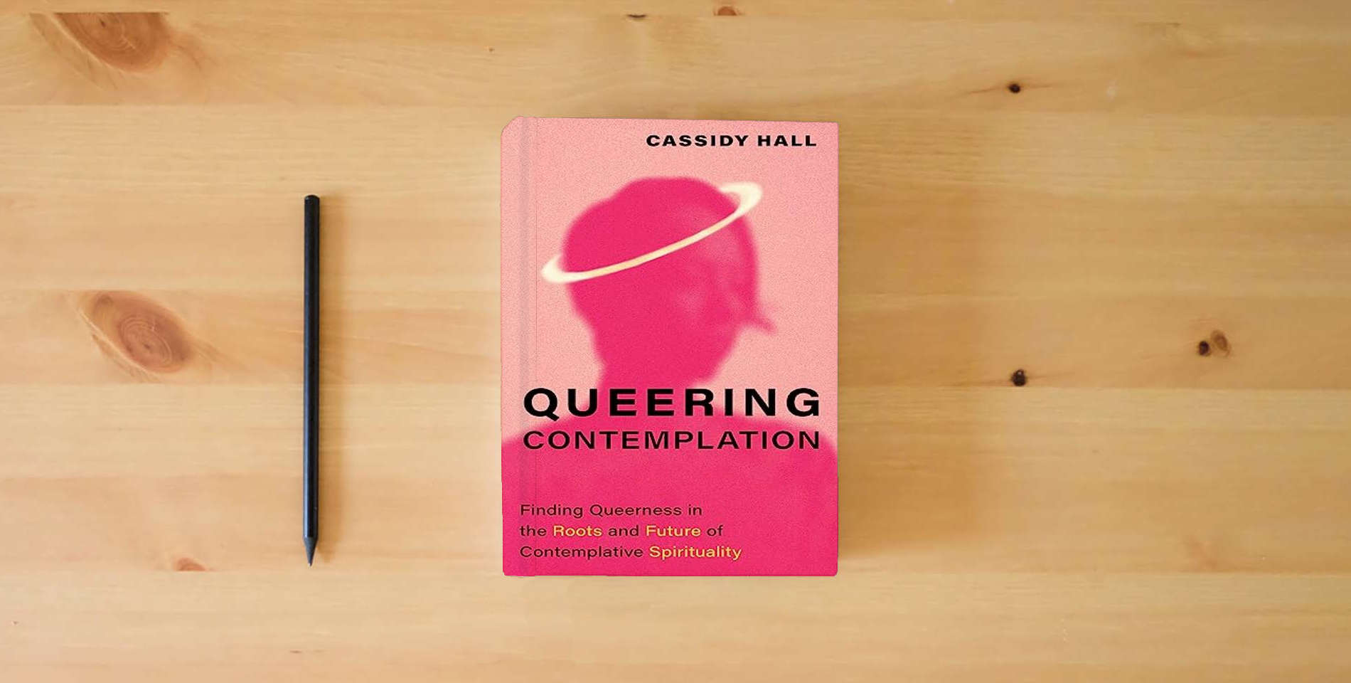 The book Queering Contemplation: Finding Queerness in the Roots and Future of Contemplative Spirituality is on the table