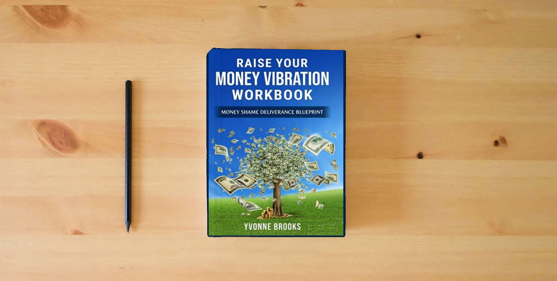 The book Raise Your Money Vibration Workbook: 12 Week Money Shame Blueprint is on the table