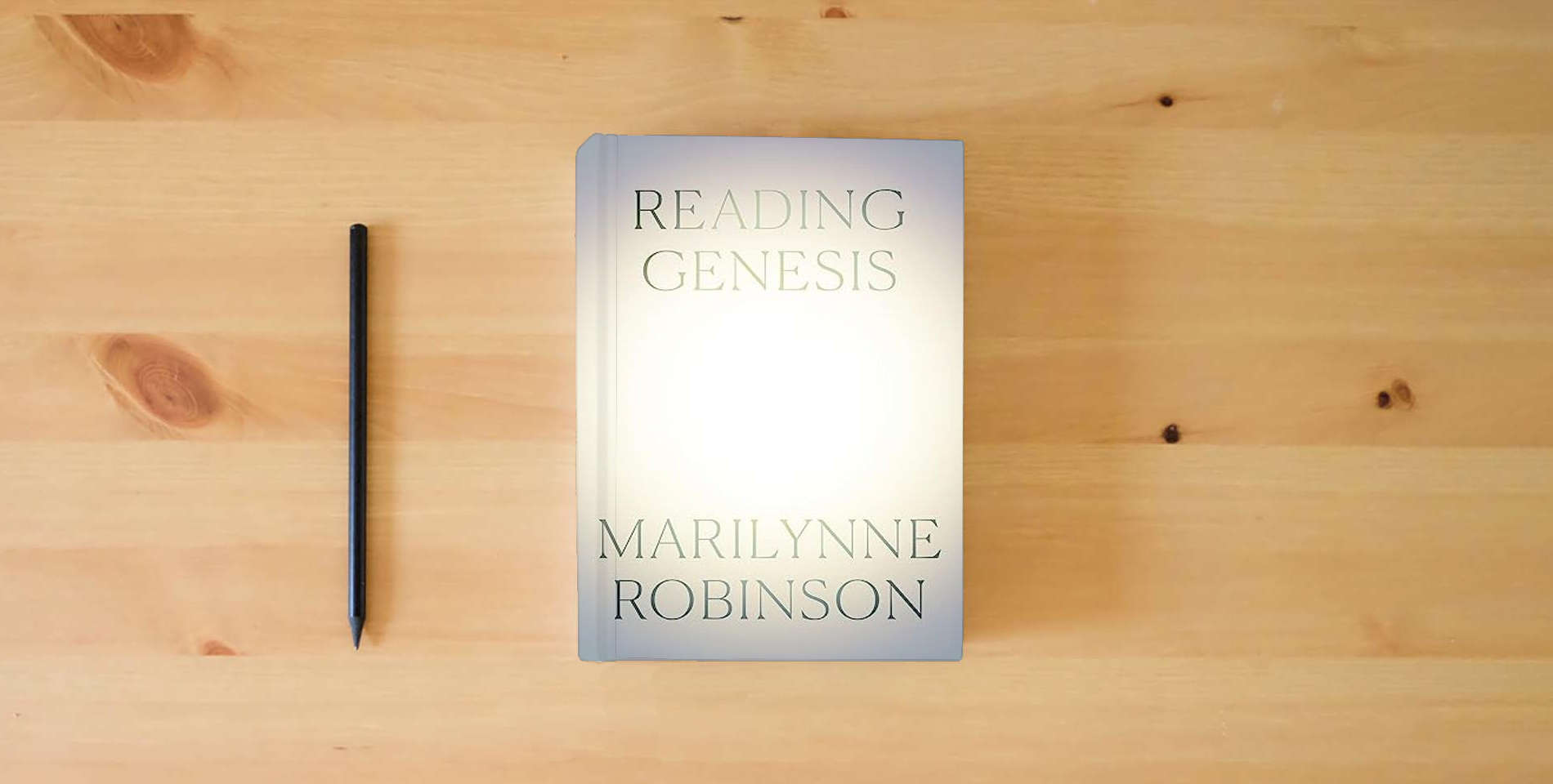 The book Reading Genesis is on the table