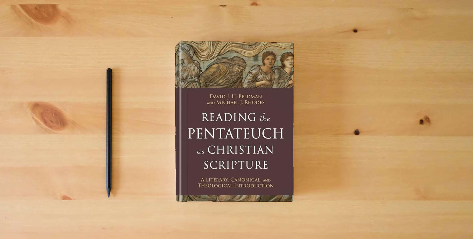 The book Reading the Pentateuch as Christian Scripture: A Literary, Canonical, and Theological Introduction (Reading Christian Scripture) is on the table