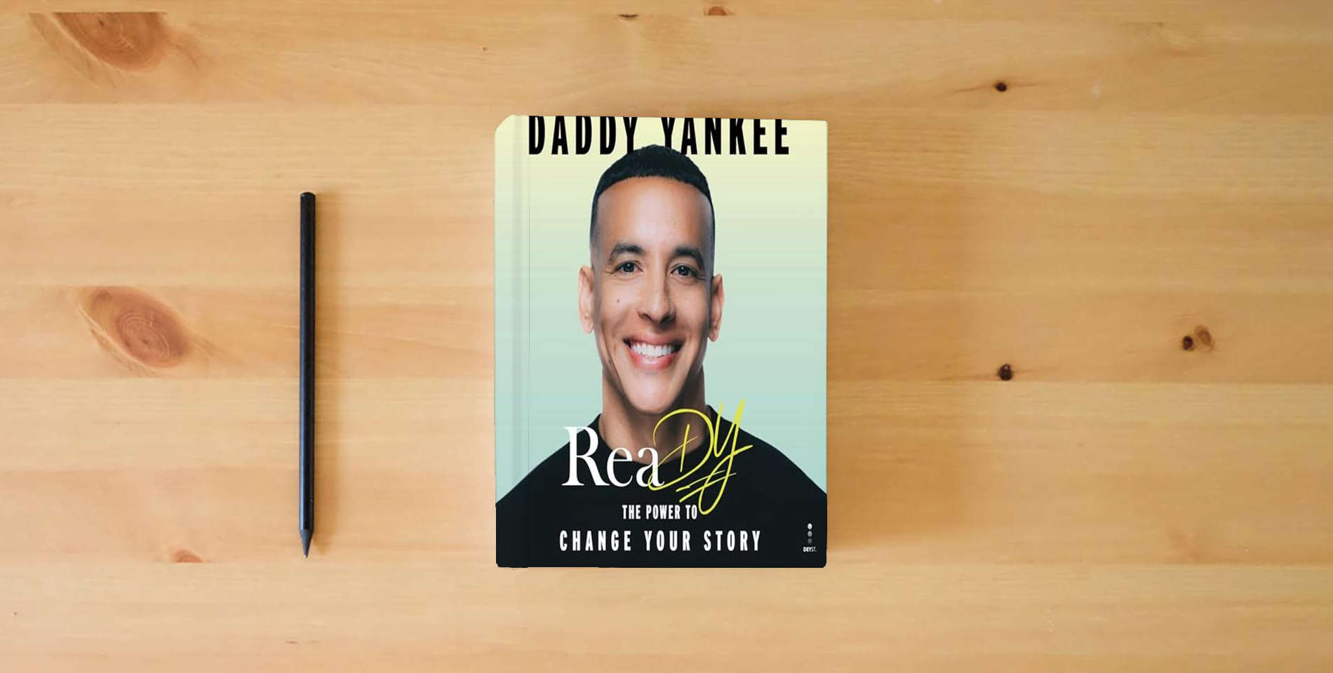 The book ReaDY: The Power to Change Your Story is on the table