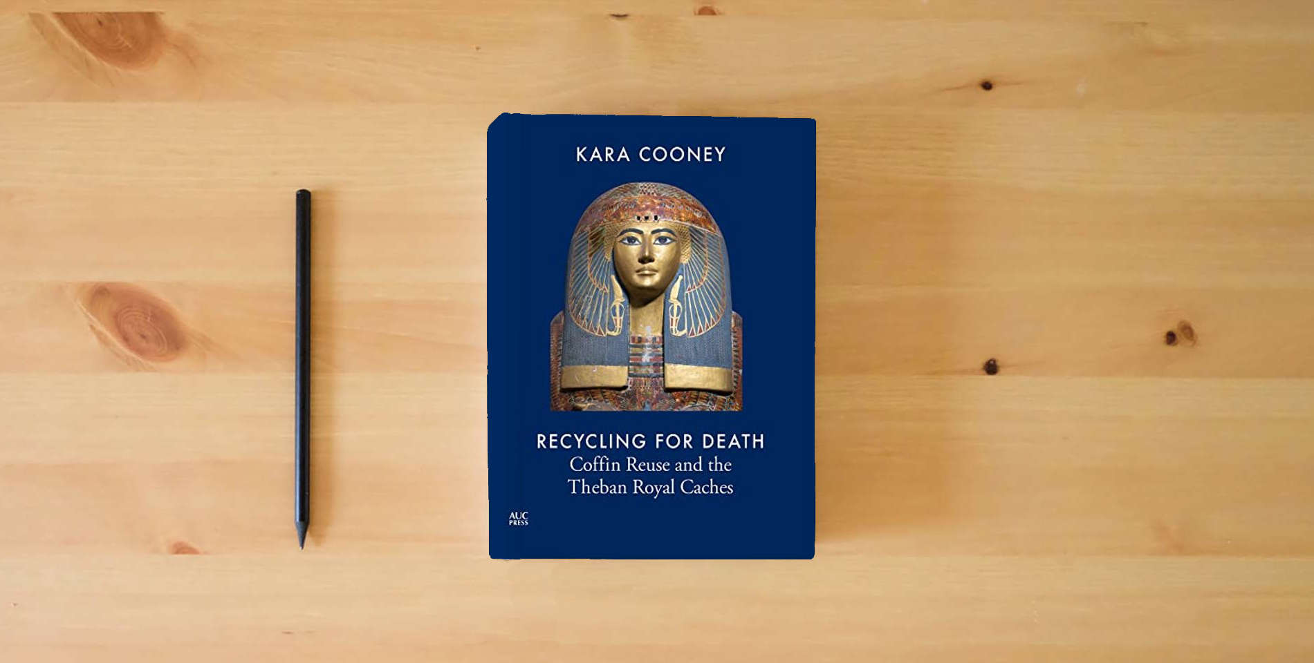 The book Recycling for Death: Coffin Reuse and the Theban Royal Caches is on the table