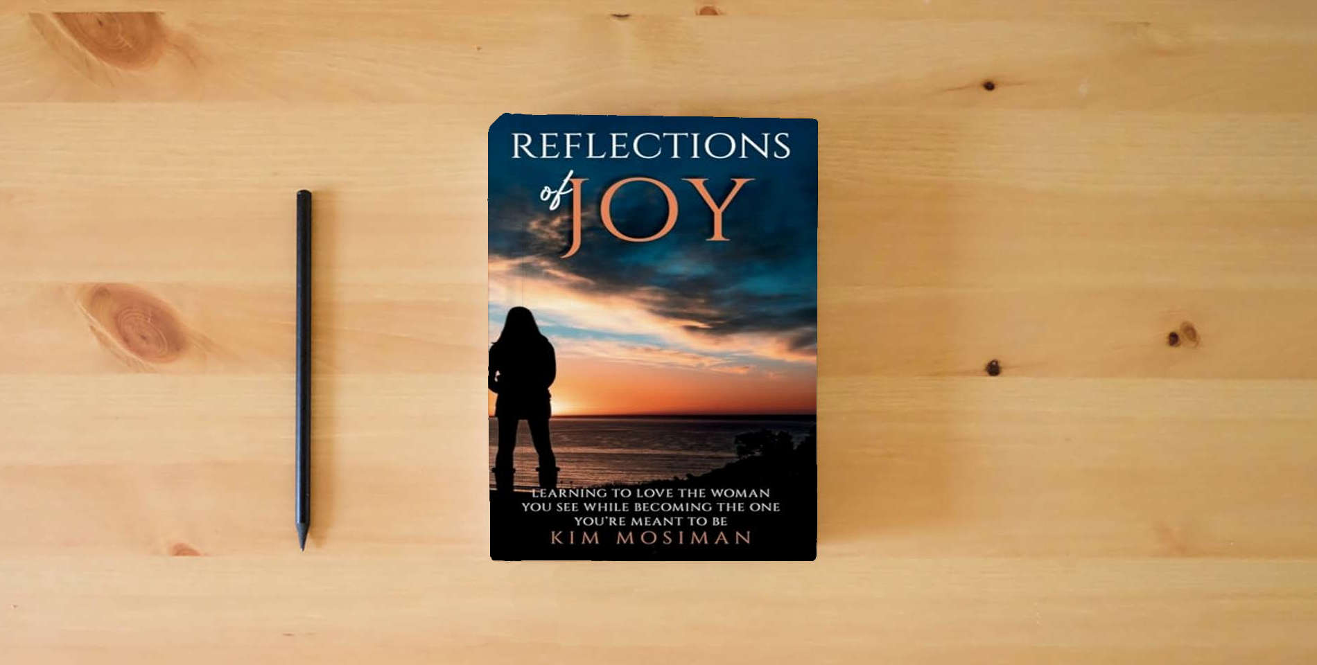 The book Reflections of Joy: Learning to Love the Woman You See While Becoming the One You're Meant to Be is on the table