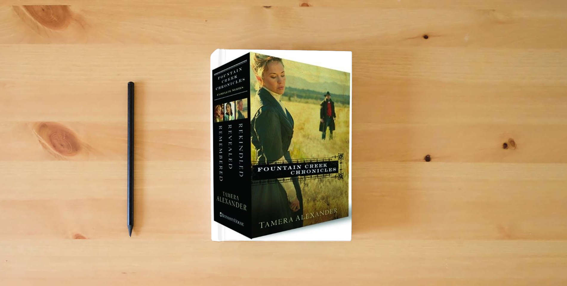 The book Rekindled/Revealed/Remembered (Fountain Creek Chronicles 1-3) is on the table