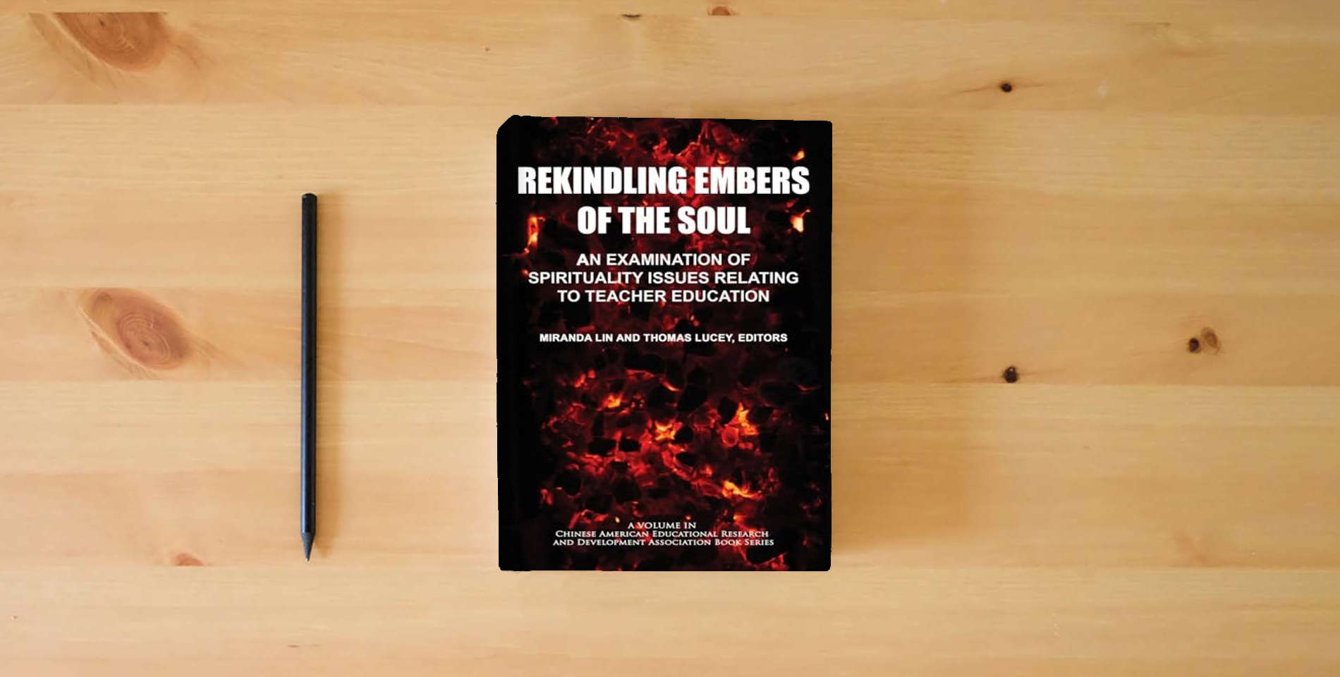 The book Rekindling Embers of the Soul: An Examination of Spirituality Issues Relating to Teacher Education (Chinese American Educational Research and Development Association Book Series) is on the table
