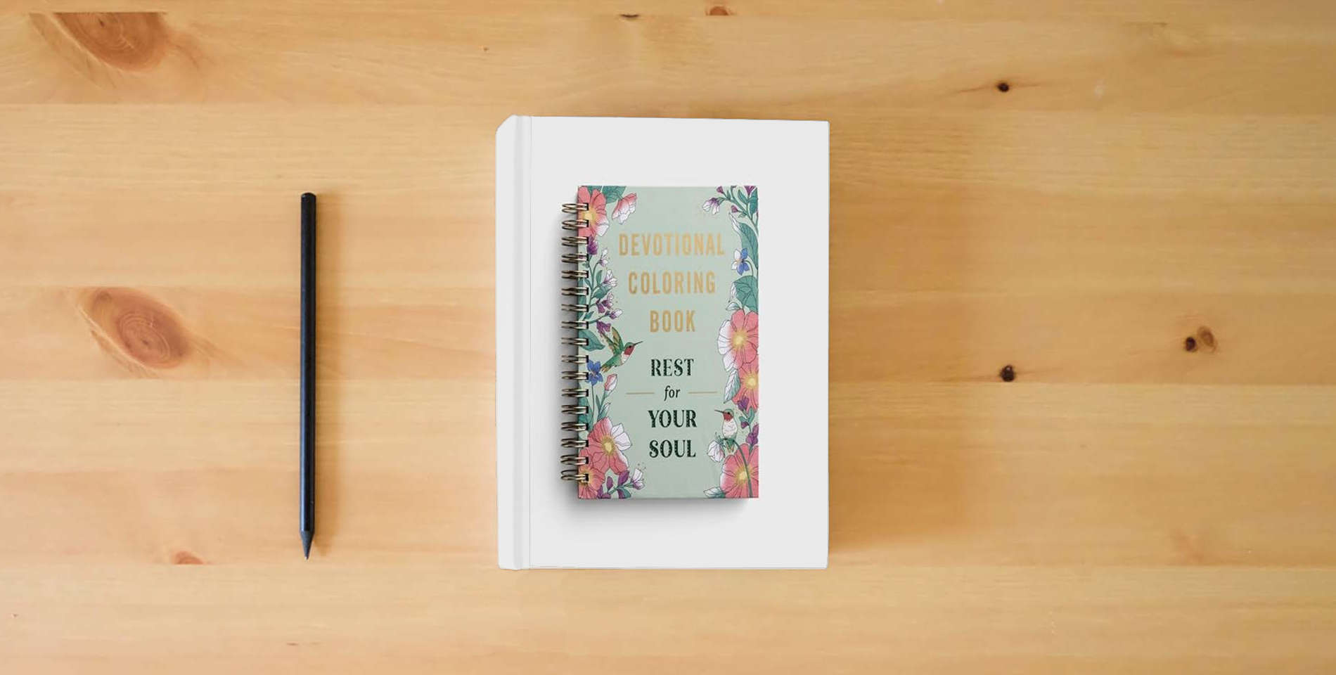 The book Rest For Your Soul: Devotional Coloring Book is on the table