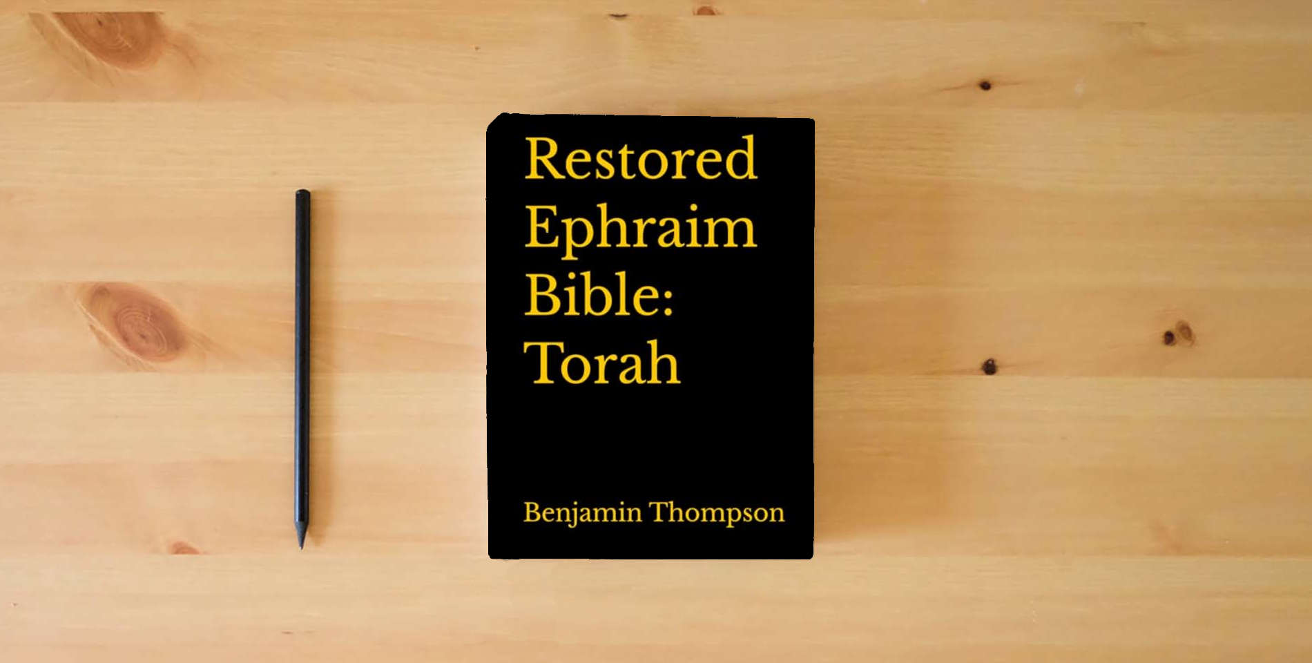 The book Restored Ephraim Bible: Torah is on the table
