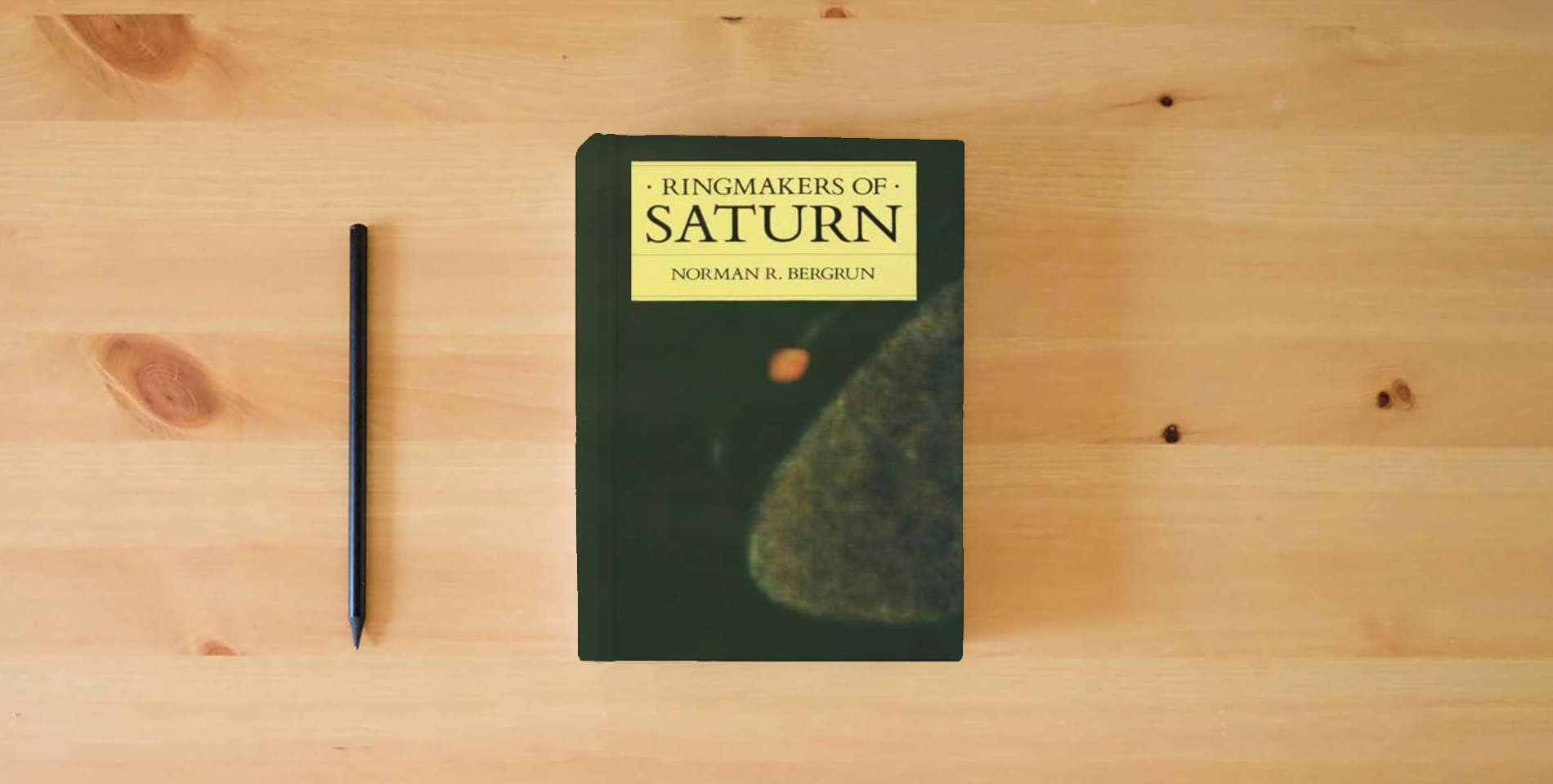 The book Ringmakers of Saturn (Revised Hardcover) is on the table