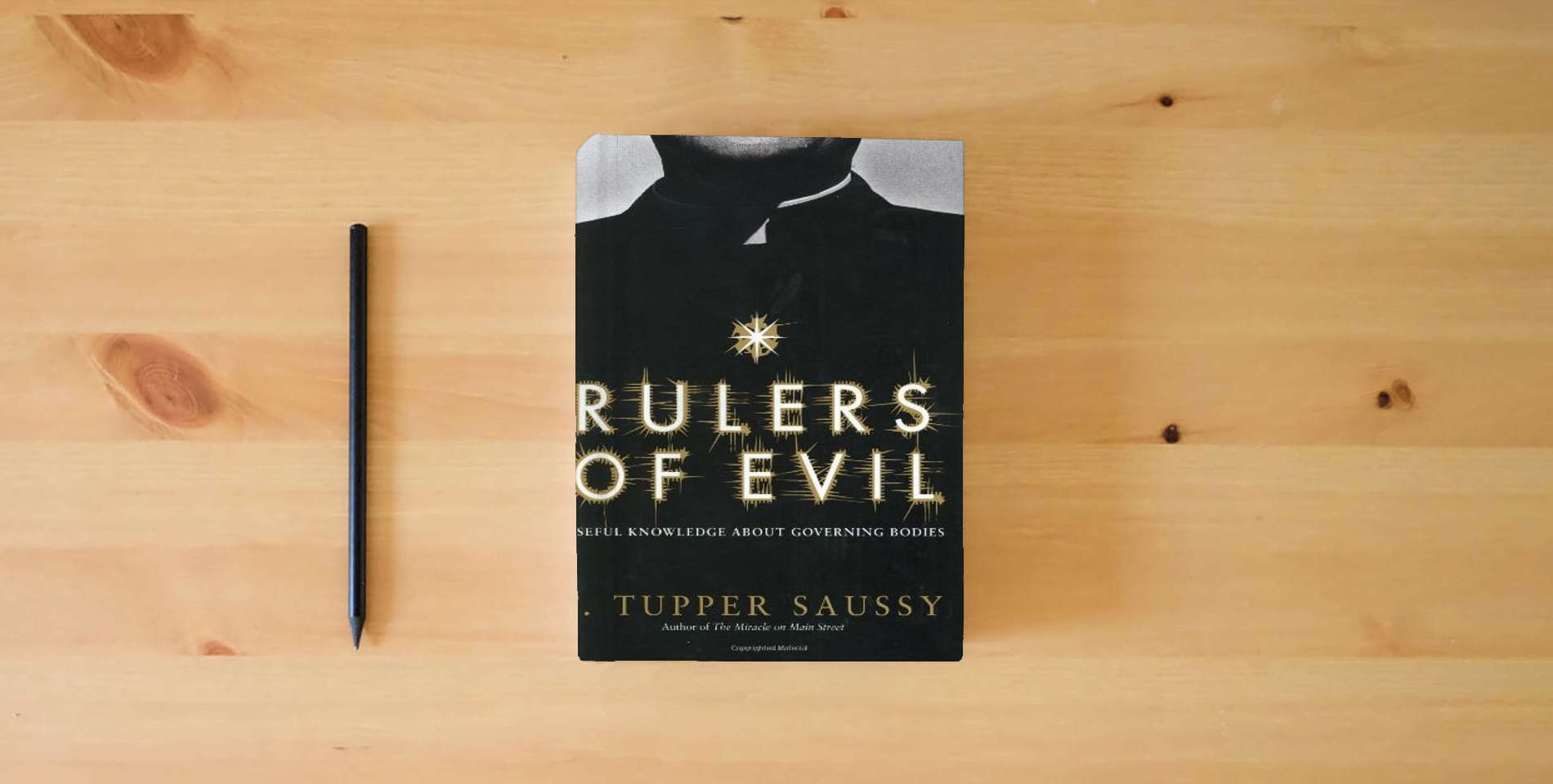 The book Rulers of Evil: Useful Knowledge about Governing Bodies is on the table