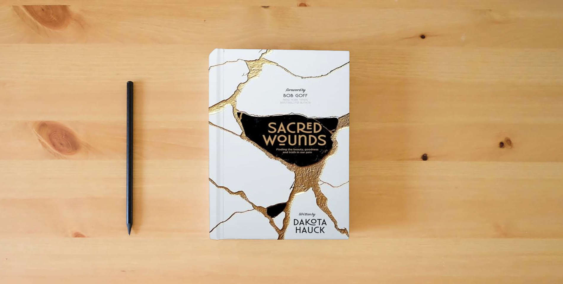 The book Sacred Wounds: Finding the Beauty, Goodness, and Truth in Our Pain is on the table
