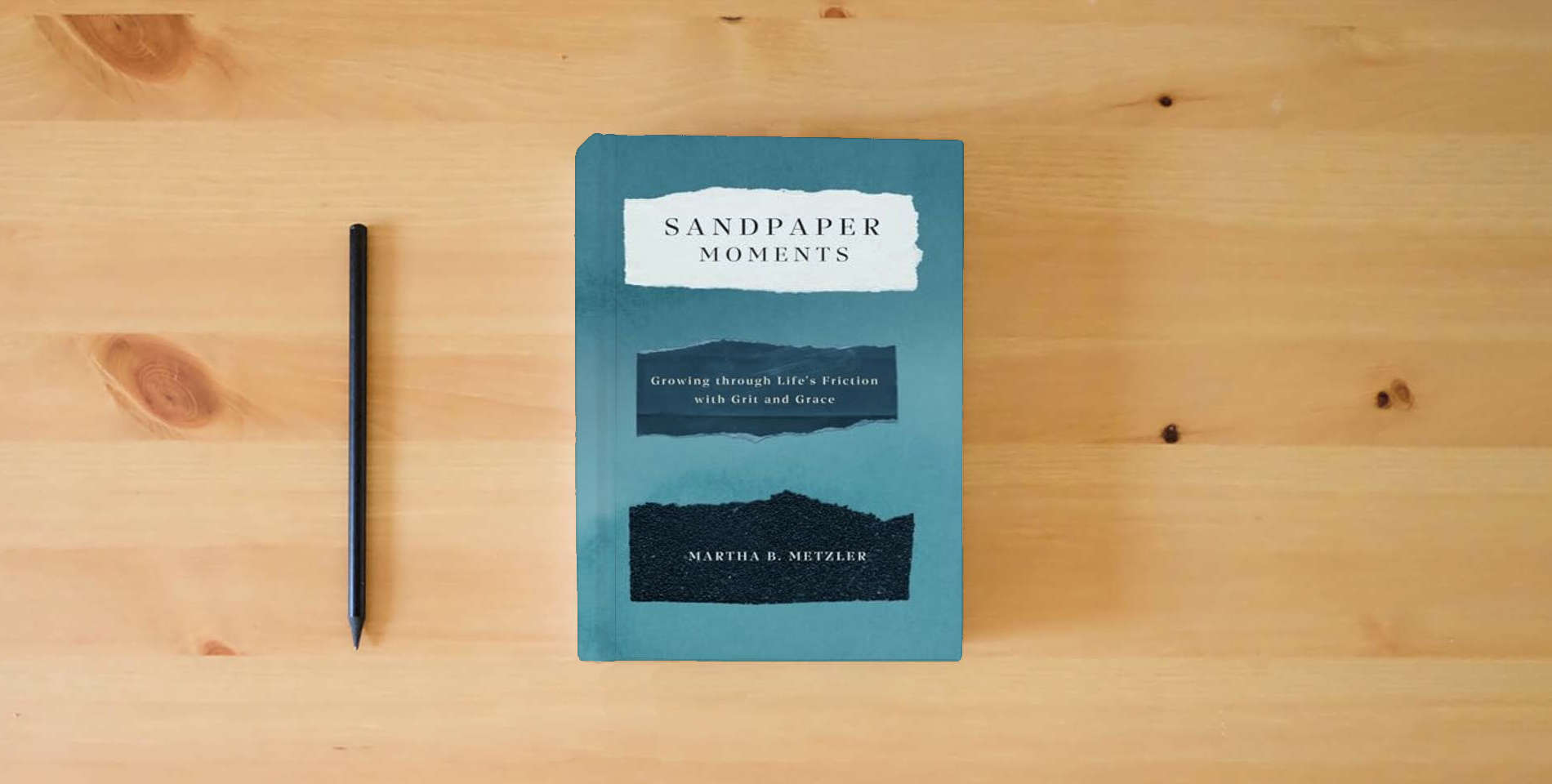 The book Sandpaper Moments: Growing Through Life’s Friction with Grit and Grace is on the table
