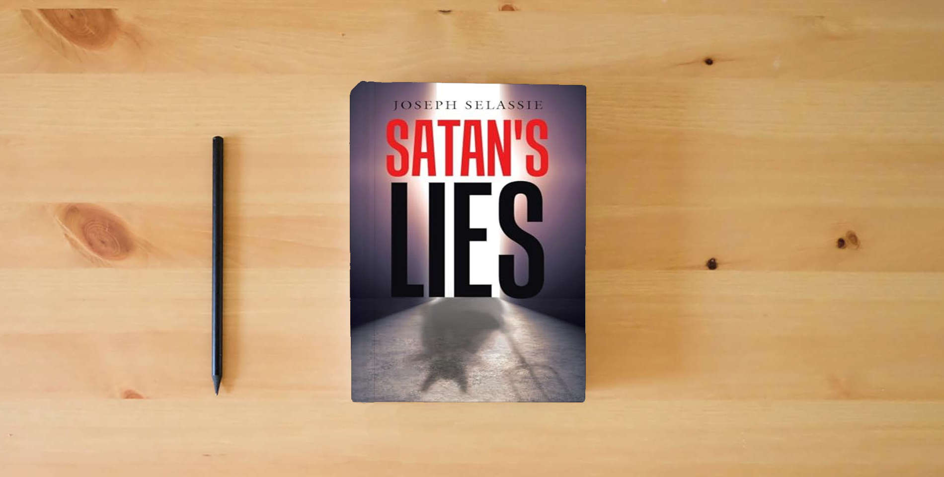The book Satan's Lies is on the table