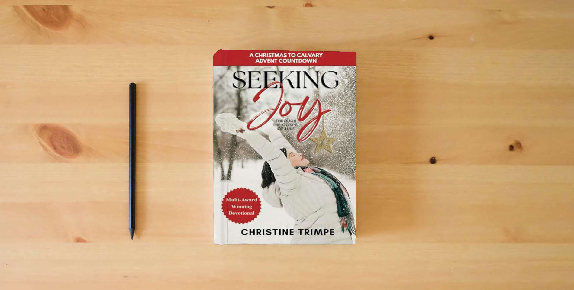 The book Seeking Joy through the Gospel of Luke: A Christmas to Calvary Advent Countdown is on the table