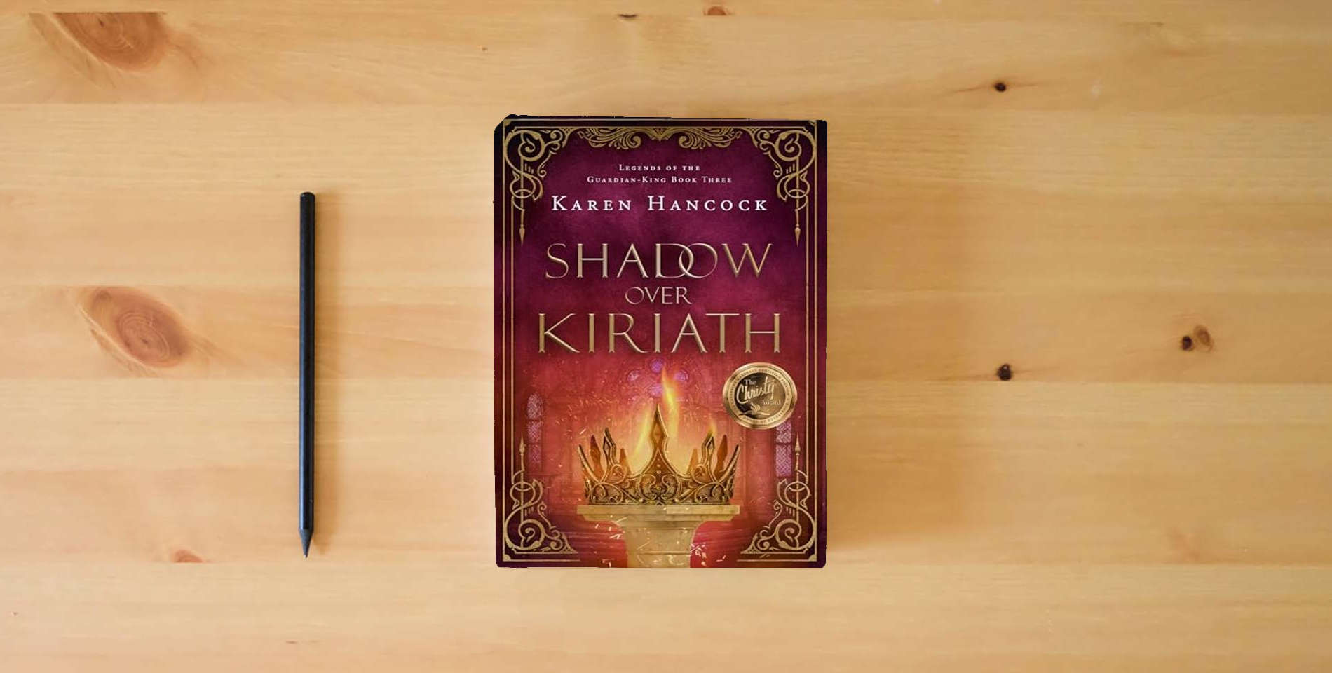 The book Shadow Over Kiriath (Volume 3) (Legends of the Guardian-King) is on the table