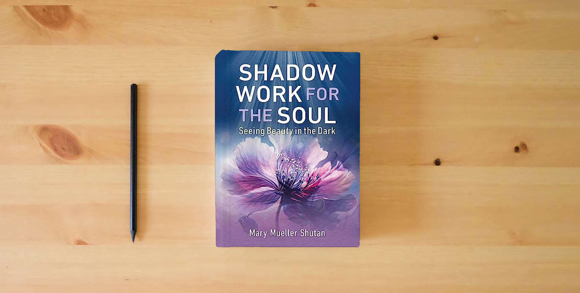 The book Shadow Work for the Soul: Seeing Beauty in the Dark is on the table