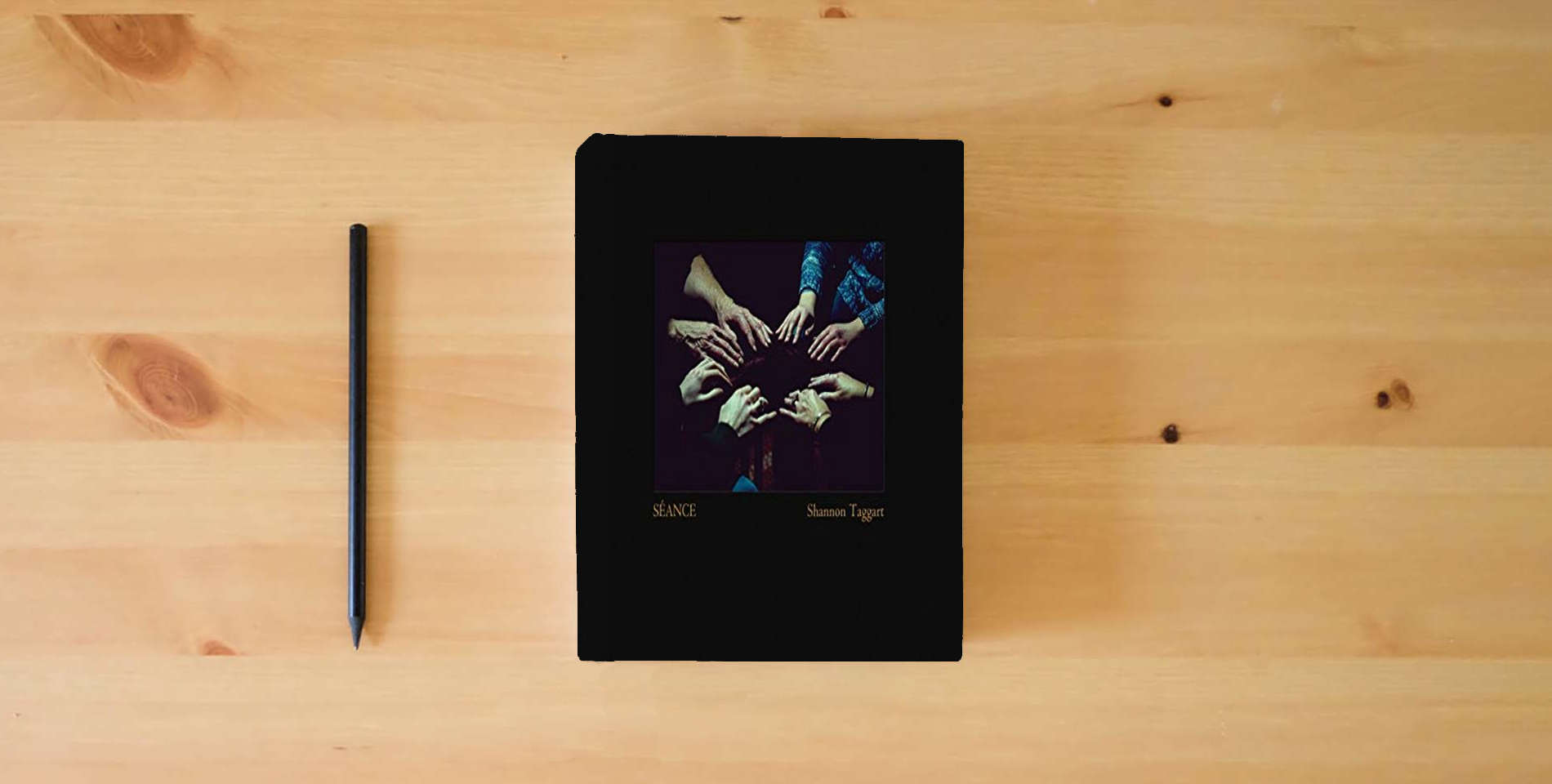 The book Shannon Taggart: Séance is on the table