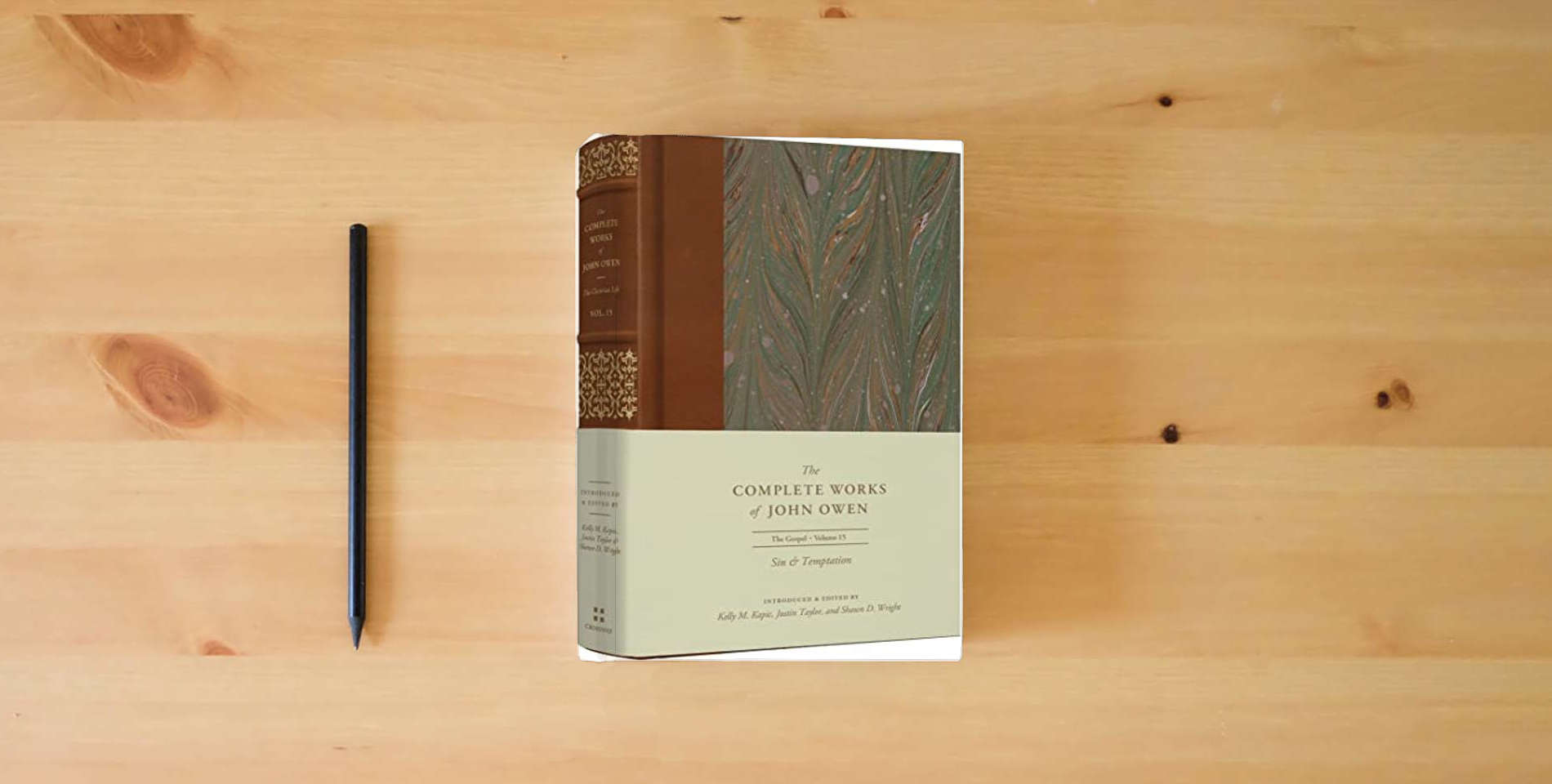 The book Sin and Temptation (Volume 15) (The Complete Works of John Owen) is on the table