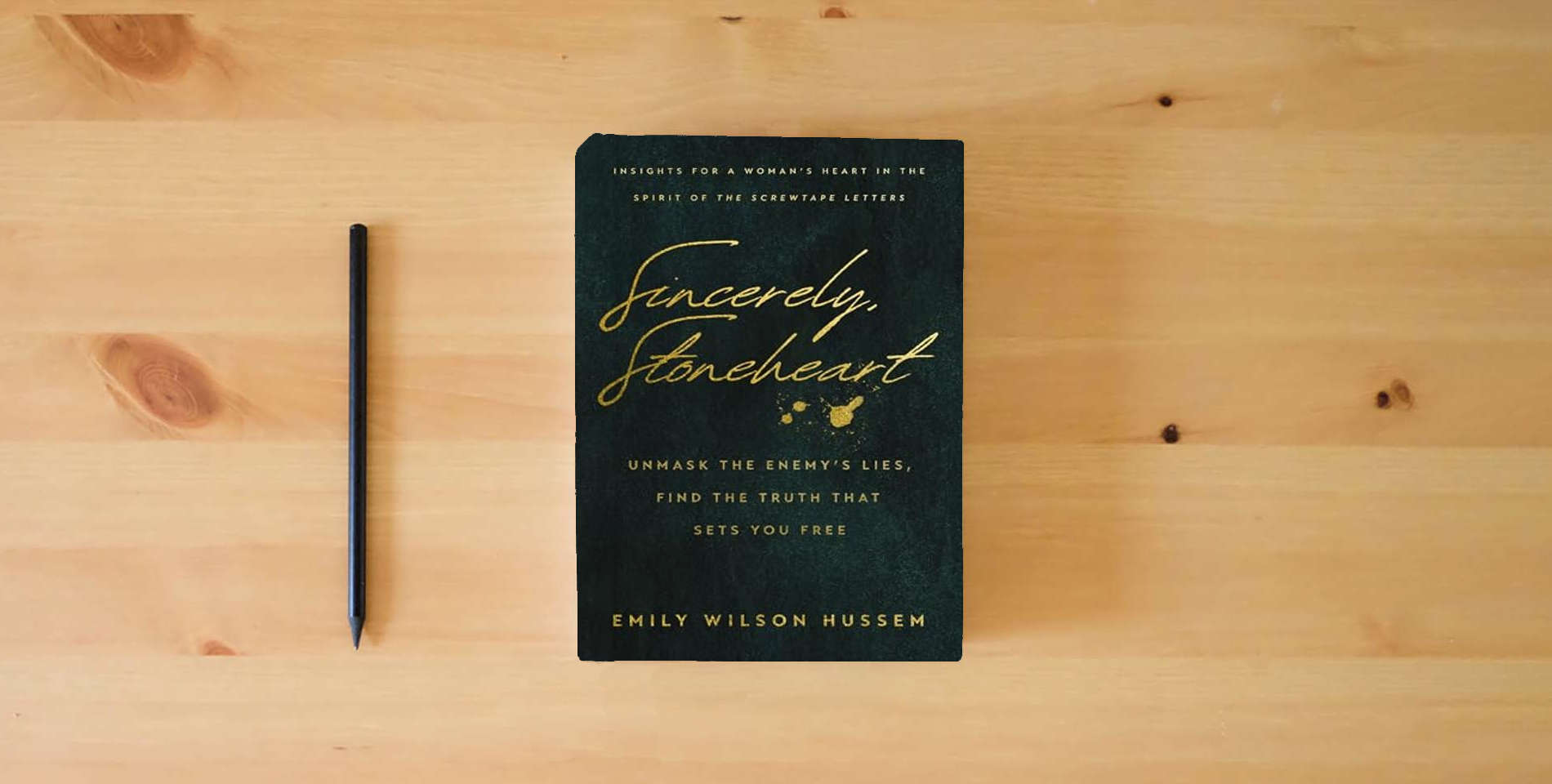 The book Sincerely, Stoneheart: Unmask the Enemy’s Lies, Find the Truth That Sets You Free (Insights for a Woman's Heart in the Spirit of the C.S. Lewis Classic, The Screwtape Letters) is on the table