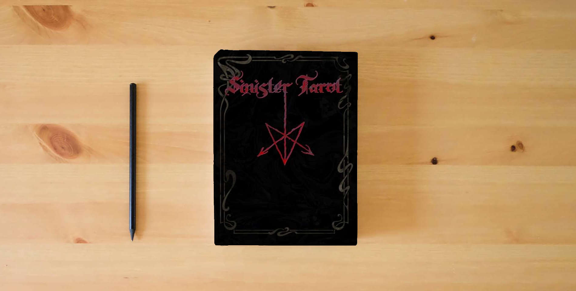The book Sinister Tarot: (Tarot of the North) is on the table