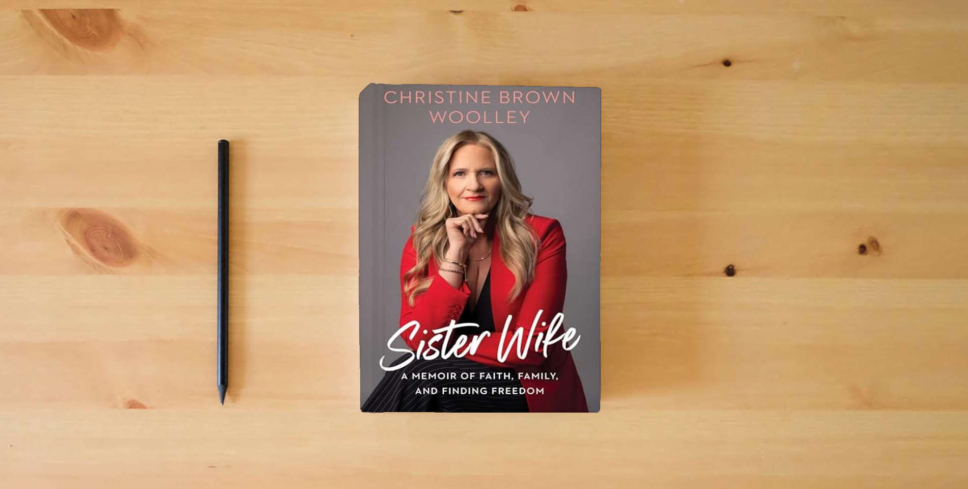 The book Sister Wife: A Memoir of Faith, Family, and Finding Freedom is on the table