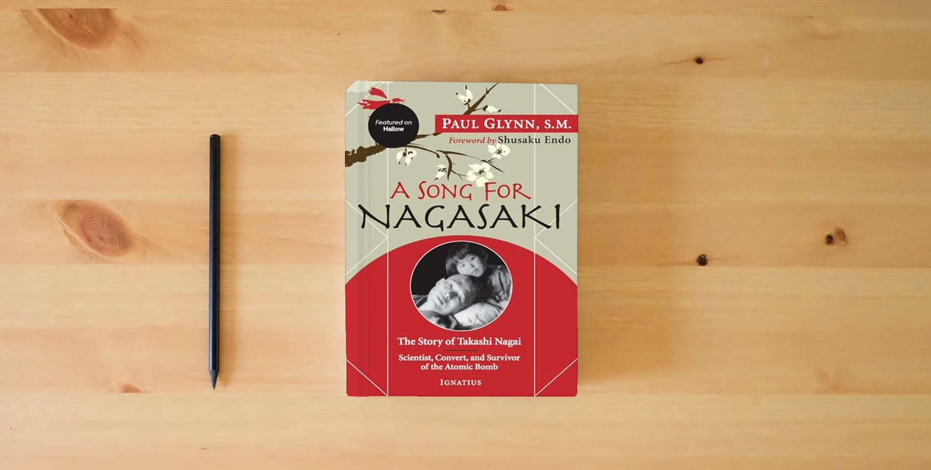The book A Song for Nagasaki - Hallow Edition: The Story of Takashi Nagai a Scientist, Convert, and Survivor of the Atomic Bomb is on the table