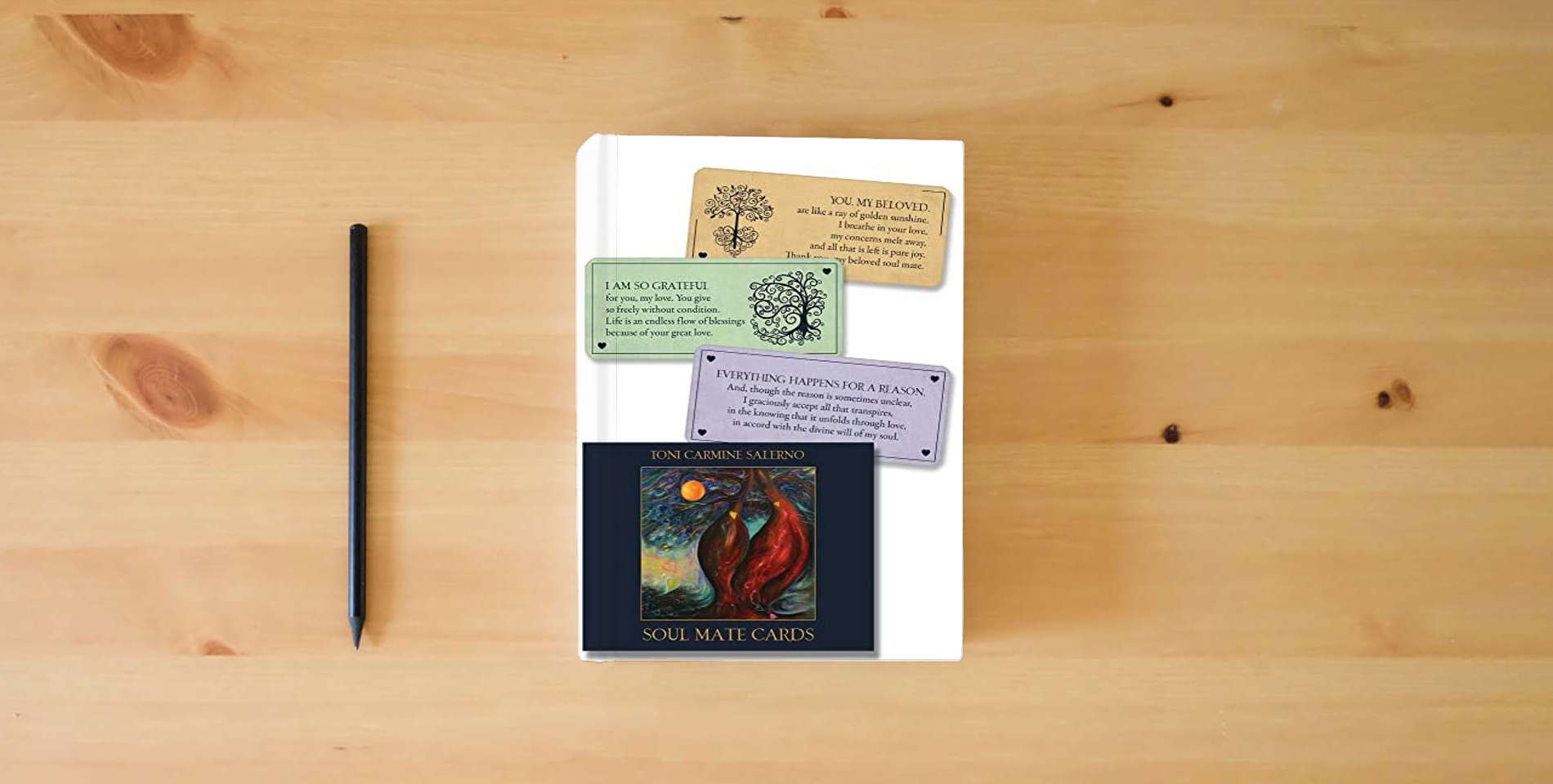 The book Soul Mate Cards New Edition: 55 Wisdom Cards for Enriching Your Soul Mate Connections is on the table