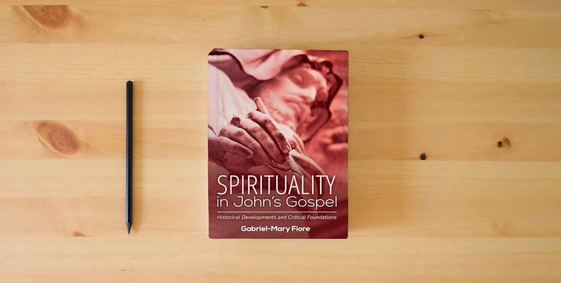 The book Spirituality in John's Gospel: Historical Developments and Critical Foundations is on the table