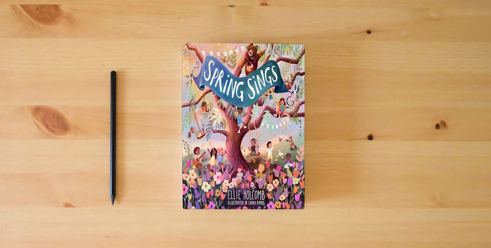 The book Spring Sings is on the table