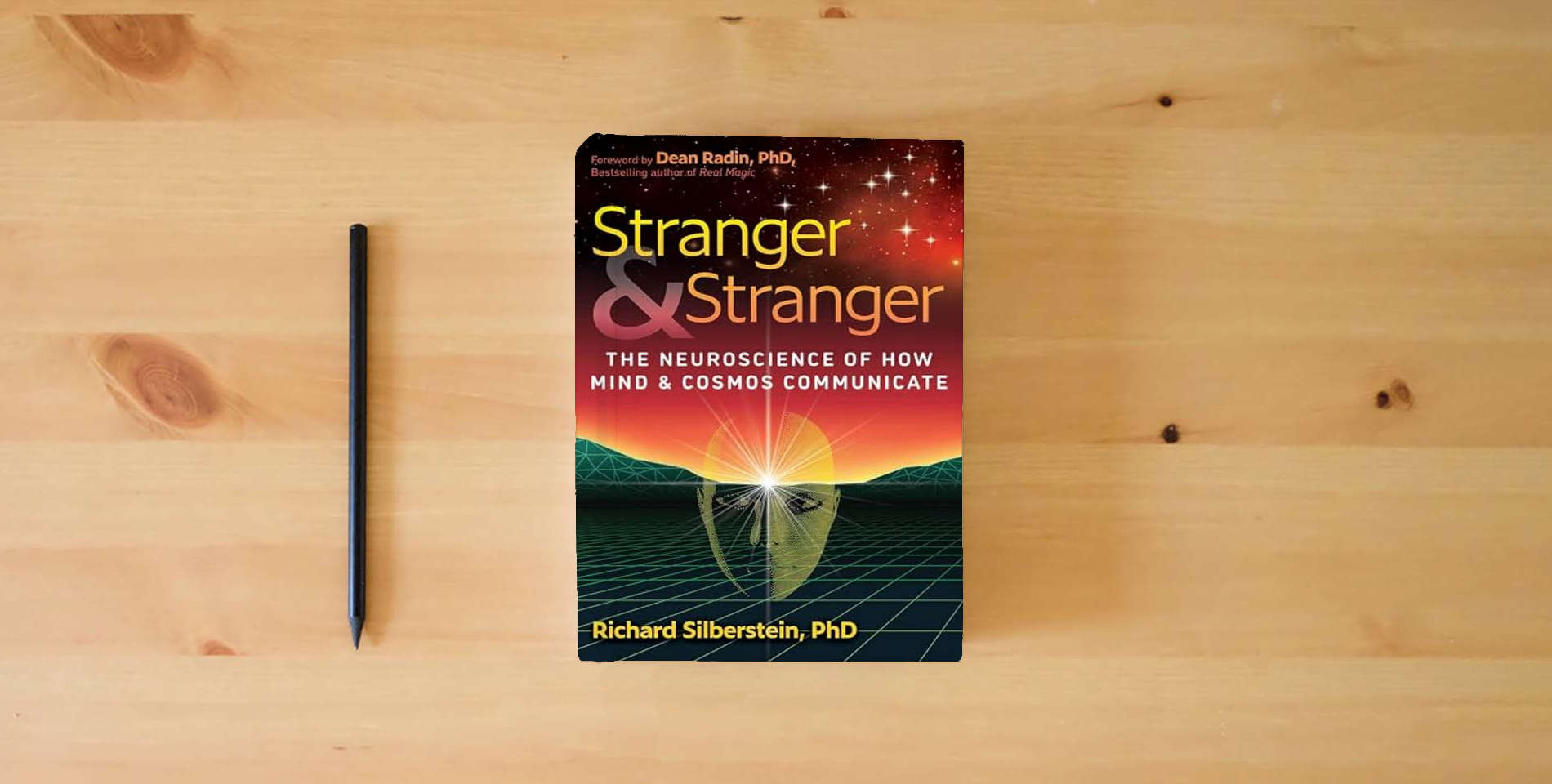 The book Stranger and Stranger: The Neuroscience of How Mind and Cosmos Communicate is on the table
