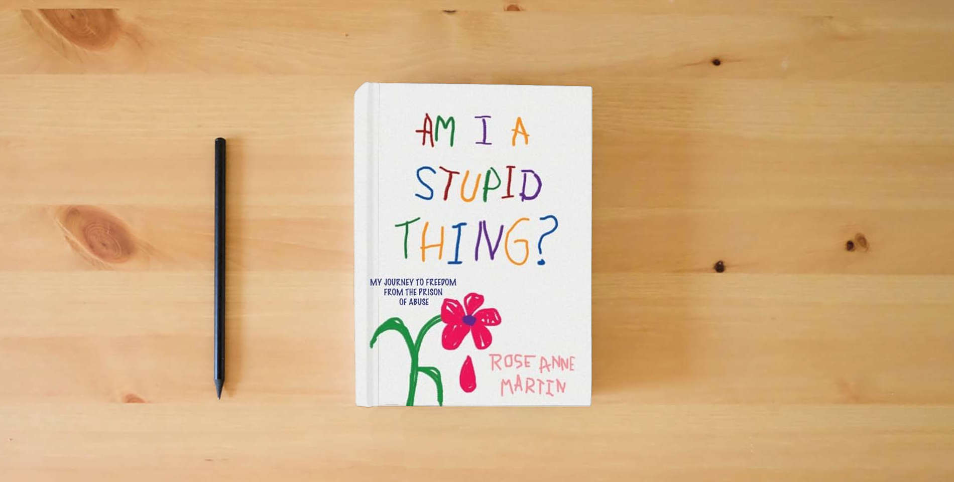 The book Am I A Stupid Thing?: My Journey From the Prison of Abuse is on the table