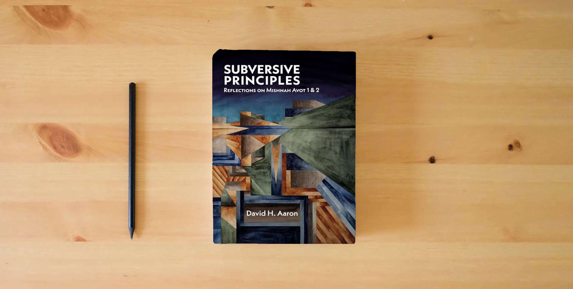 The book Subversive Principles: Reflections on Mishnah Avot 1 & 2 is on the table