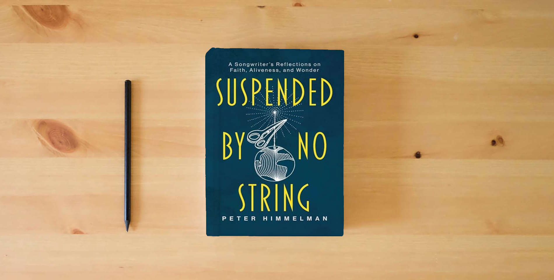 The book Suspended by No String: A Songwriter's Reflections on Faith, Aliveness, and Wonder is on the table