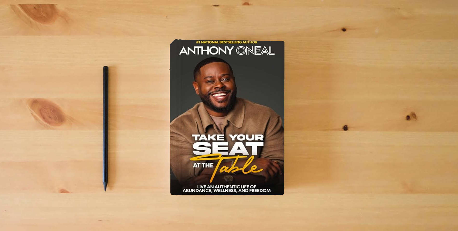The book Take Your Seat at the Table: Live an Authentic Life of Abundance, Wellness, and Freedom is on the table
