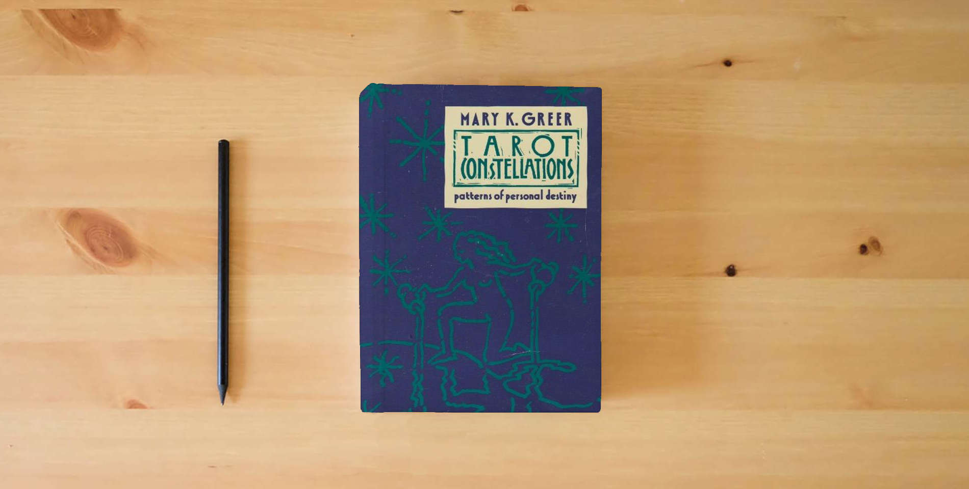 The book Tarot Constellations: Patterns of Personal Destiny is on the table