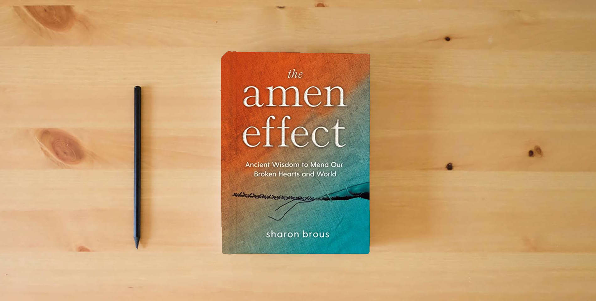 The book The Amen Effect: Ancient Wisdom to Mend Our Broken Hearts and World is on the table