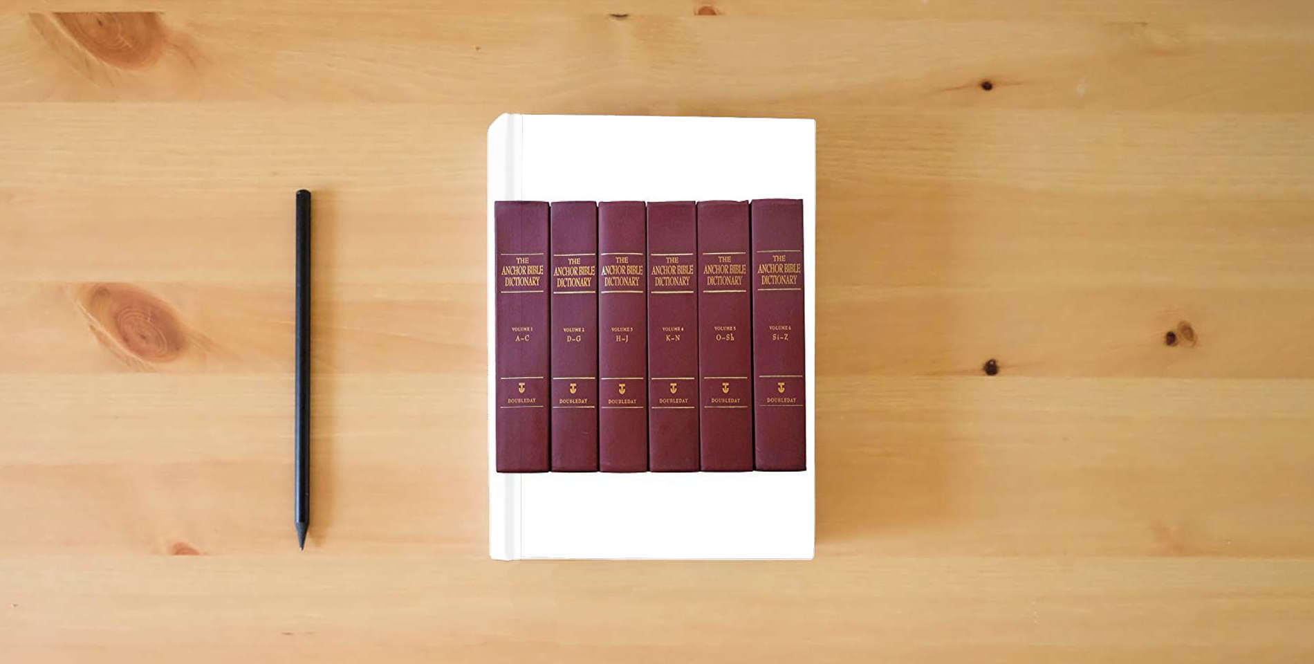 The book The Anchor Bible Dictionary (6 Volume Set) is on the table