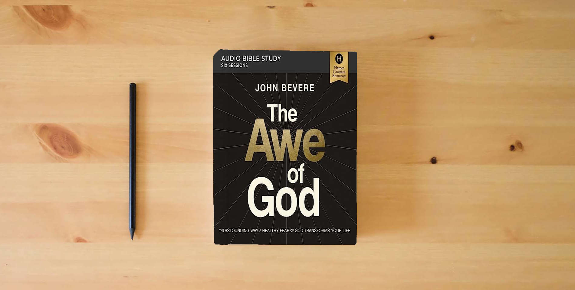 The book The Awe of God: Audio Bible Studies: The Astounding Way a Healthy Fear of God Transforms Your Life is on the table