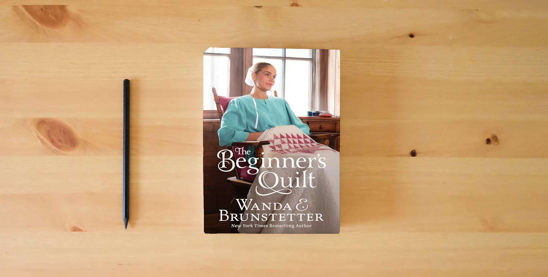 The book The Beginner's Quilt is on the table