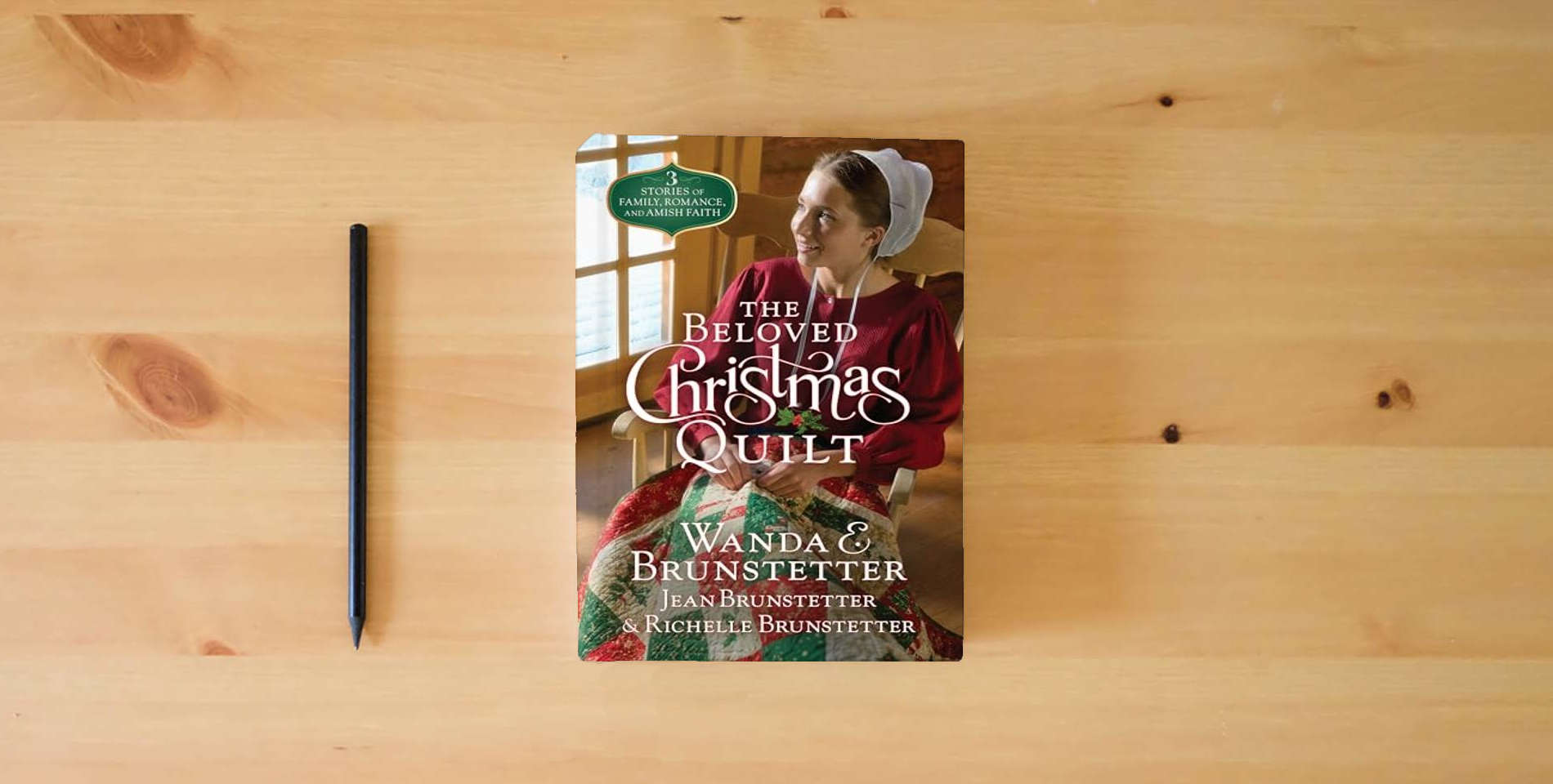 The book The Beloved Christmas Quilt is on the table