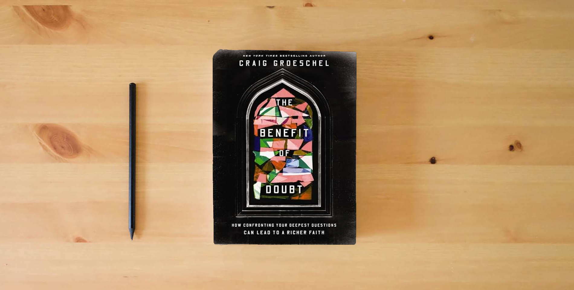 The book The Benefit of Doubt: How Confronting Your Deepest Questions Can Lead to a Richer Faith is on the table
