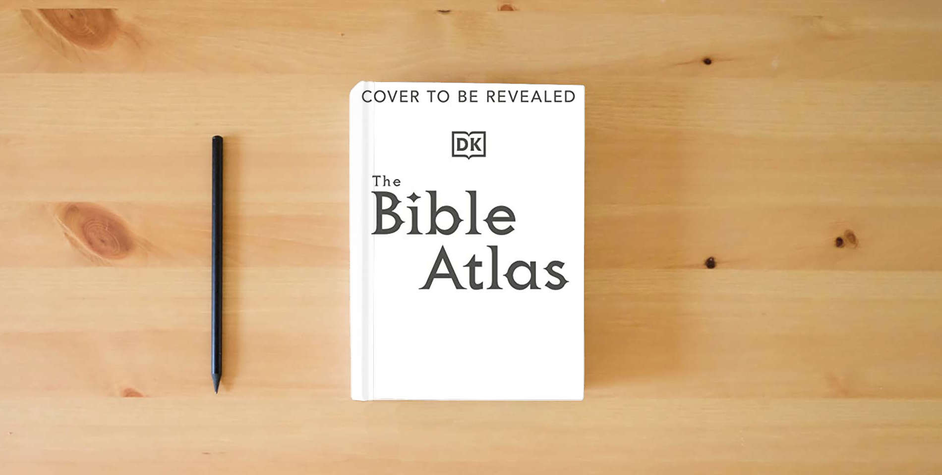 The book The Bible Atlas is on the table