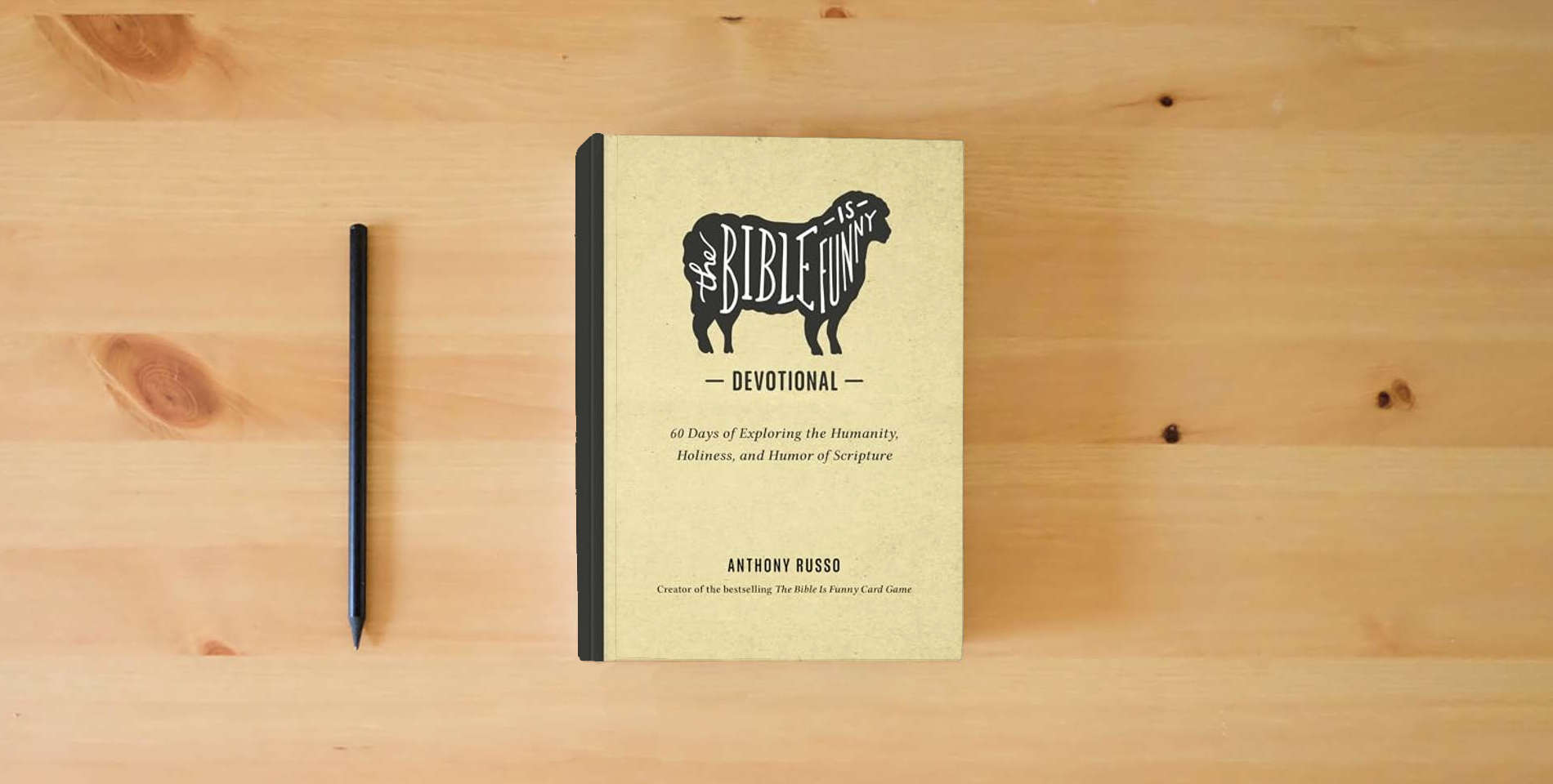 The book The Bible Is Funny Devotional: 60 Days of Exploring the Humanity, Holiness, and Humor of Scripture is on the table