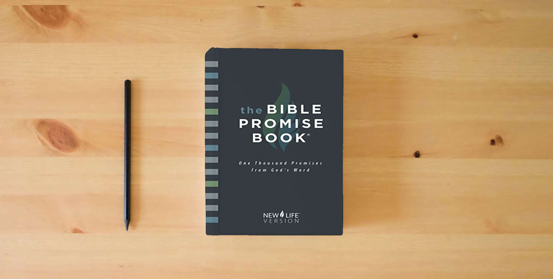 The book The Bible Promise Book: New Life Version is on the table