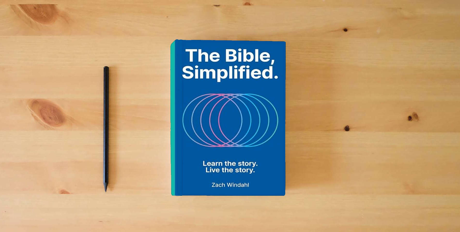The book The Bible, Simplified: Learn the Story, Live the Story is on the table