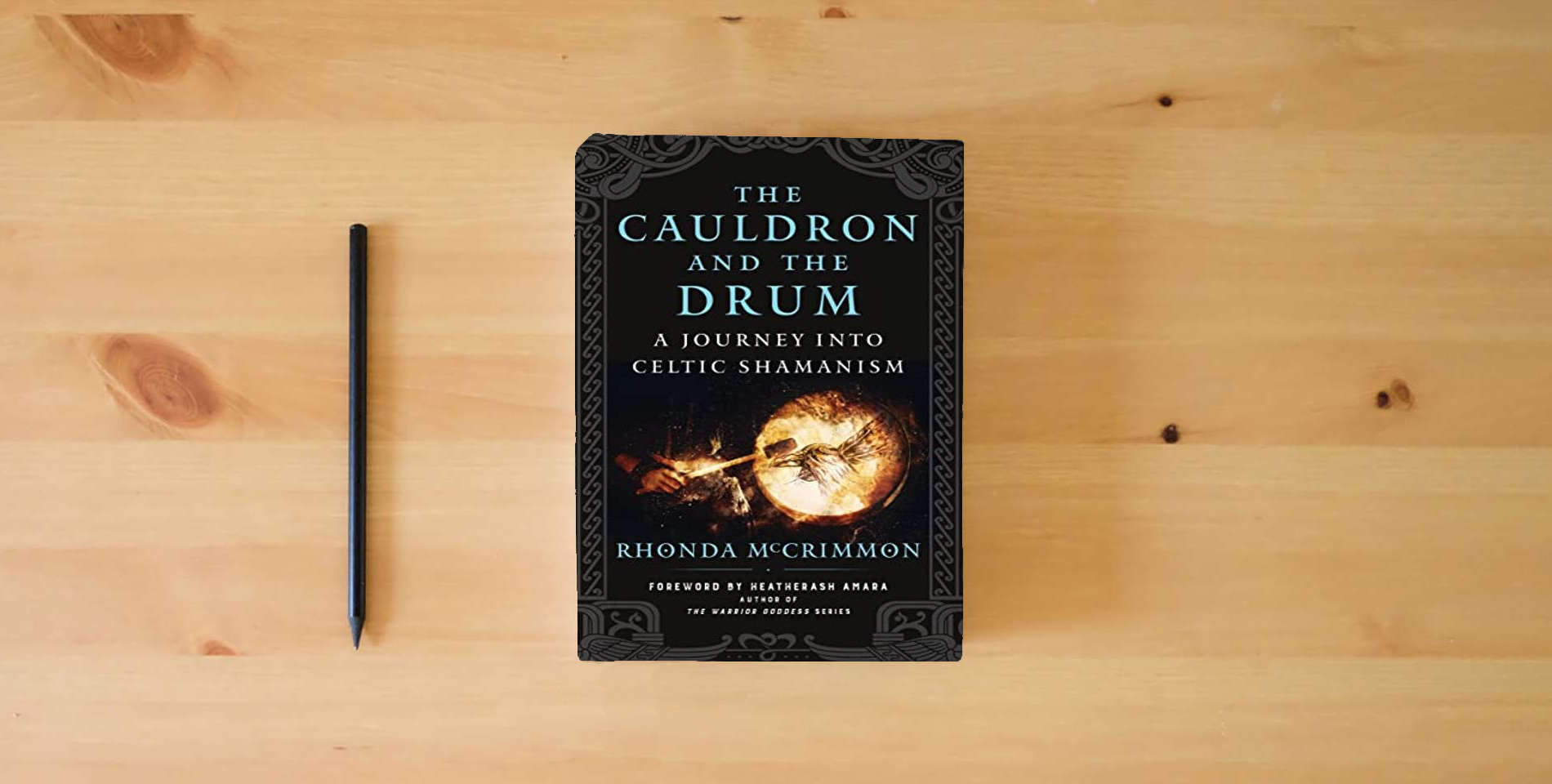 The book The Cauldron and the Drum: A Journey into Celtic Shamanism is on the table