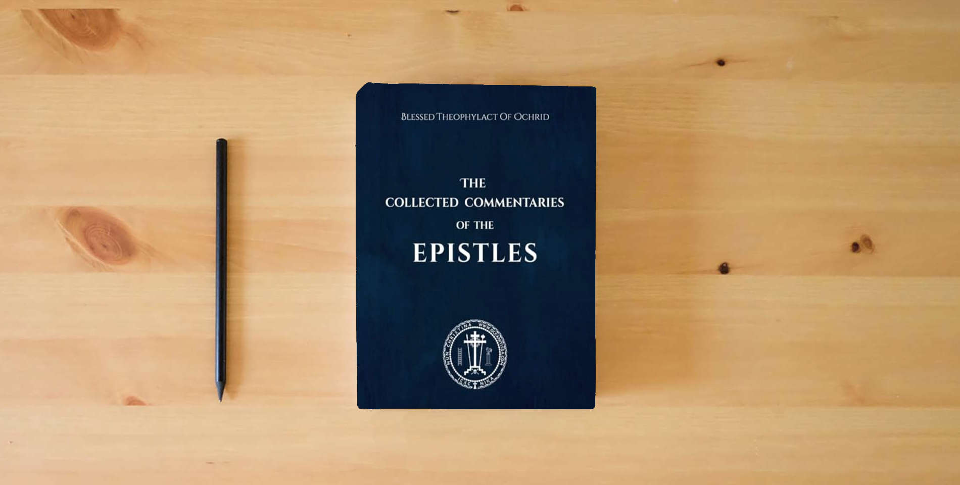The book The Collected Commentaries of the Epistles is on the table