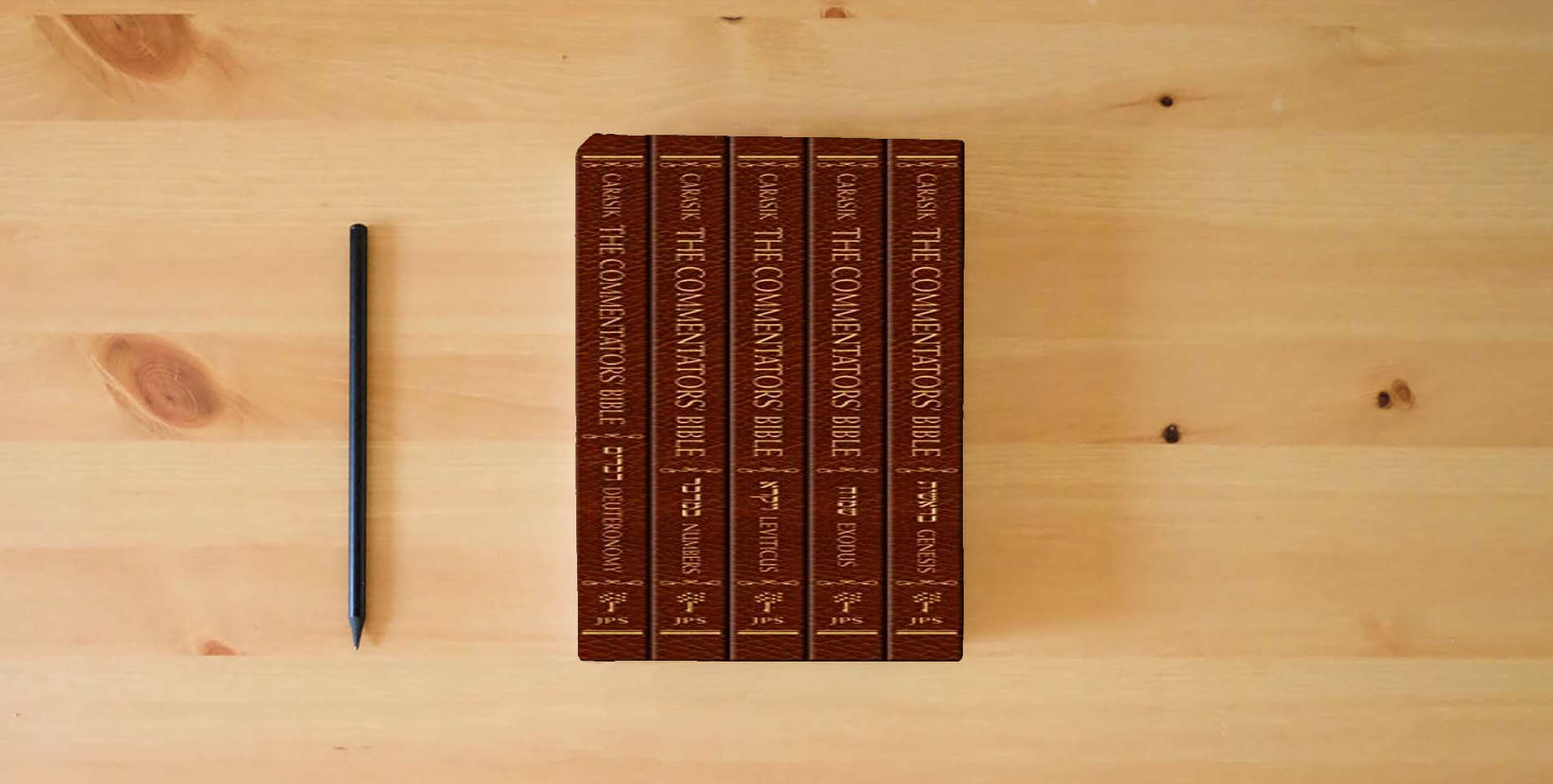 The book The Commentators' Bible, 5-volume set: The Rubin JPS Miqra'ot Gedolot is on the table