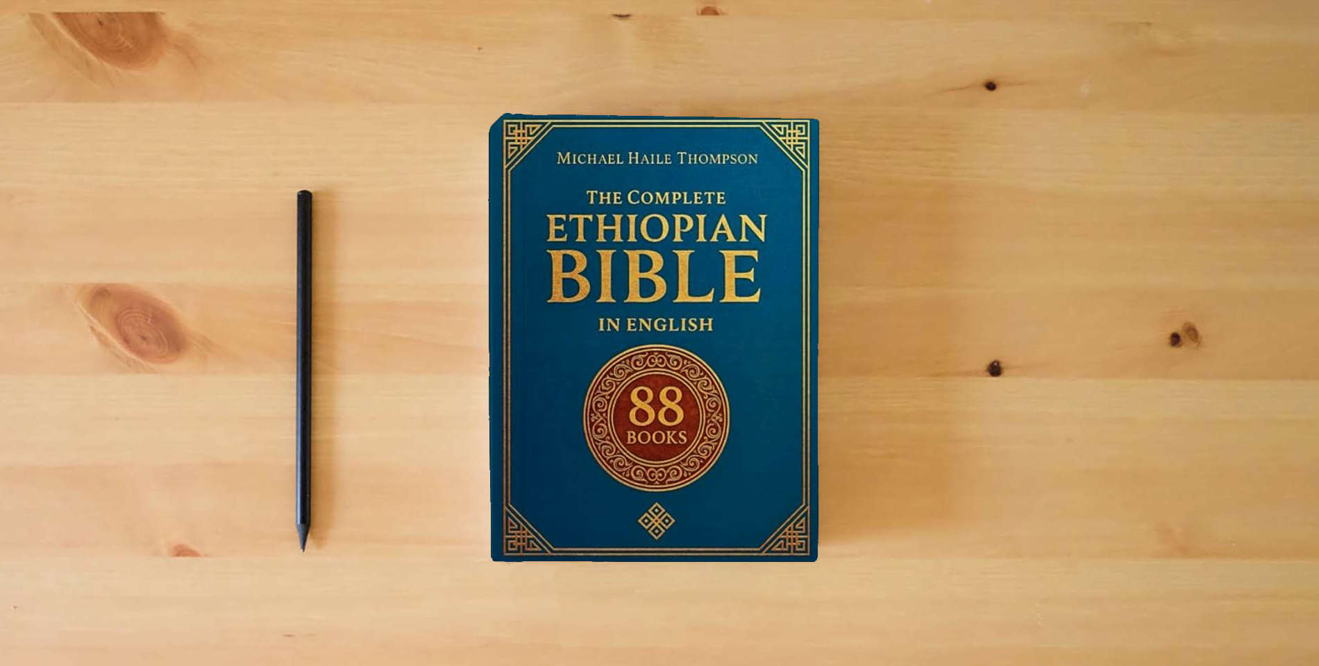 The book The Complete ETHIOPIAN BIBLE in English: Groundbreaking Translation and Critical Commentary Including Apocrypha, Enoch, Jubilees, and Other Rare Texts is on the table