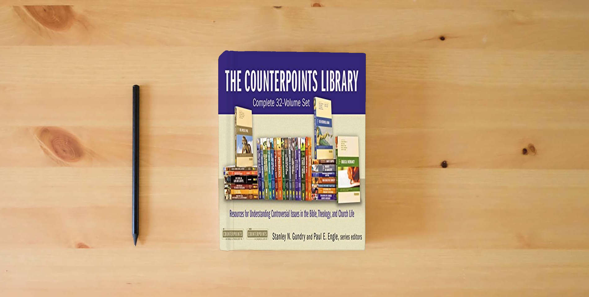 The book The Counterpoints Library: Complete 32-Volume Set: Resources for Understanding Controversial Issues in the Bible, Theology, and Church Life (Counterpoints: Bible and Theology) is on the table